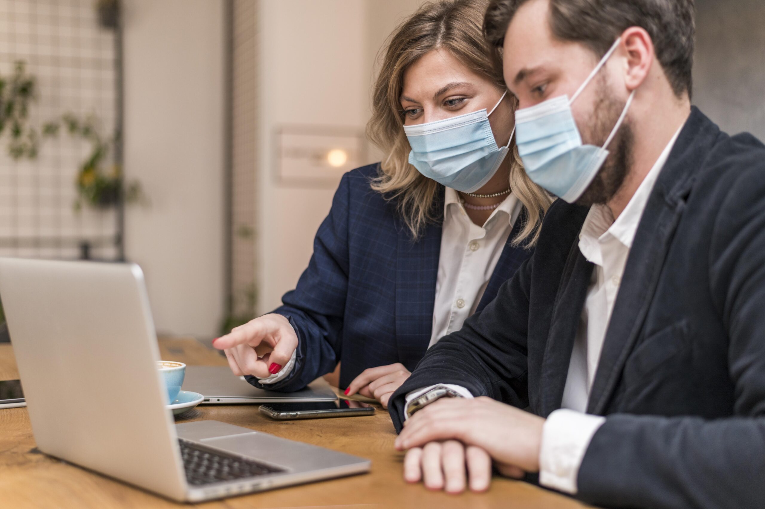 business-man-woman-talking-about-new-project-while-wearing-medical-masks