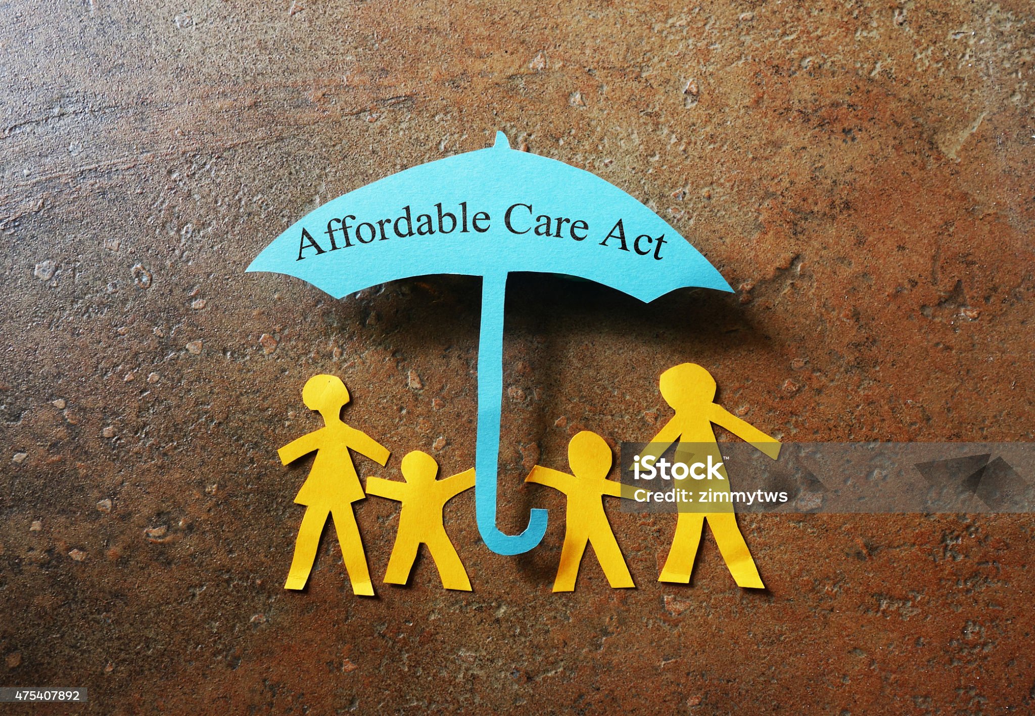 Paper family of four under a Affordable Care Act umbrella