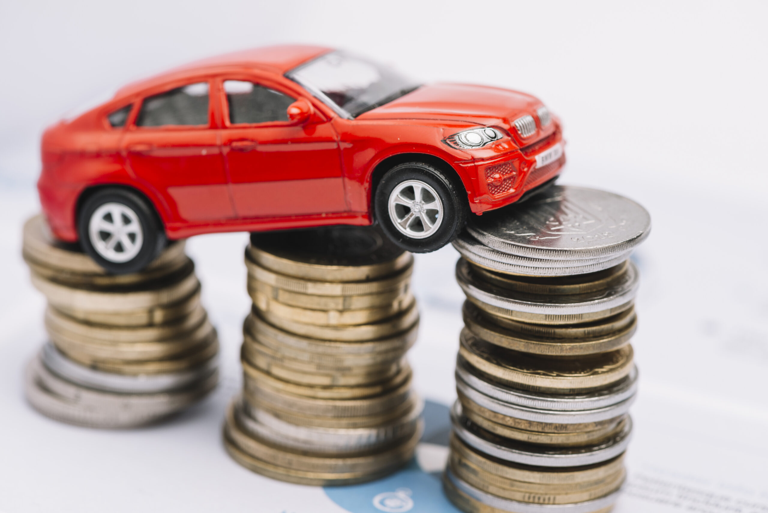 small-red-car-stack-increasing-coins